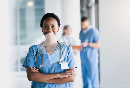 Image of Happy, nurse and portrait of black woman with arms crossed in hospital for healthcare, wellness and nursing career. Face of African surgeon, confident medical professional worker and employee smile