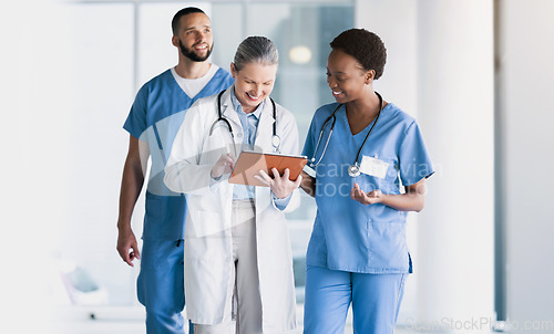 Image of Doctor, team and tablet in research, schedule planning or online search together at hospital. Group of happy medical or healthcare employees with technology in teamwork for surgery plan at clinic