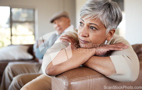 Image of Divorce, stress and senior couple on a sofa fight, argue and angry at home together. Marriage, doubt and elderly woman thinking in living room with debt, fear or anxiety while ignoring toxic partner
