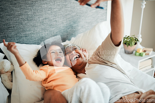 Image of Selfie, grandmother and relax child on bed bonding, excited and love for happy family with care. Photography, technology and senior woman with little girl in bedroom on video call together in home.
