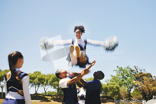 Image of Teamwork, air or cheerleader training in fitness workout, exercise or learning a jump routine on field. Catch, dance or sports woman in group for motivation, inspiration or support on college campus