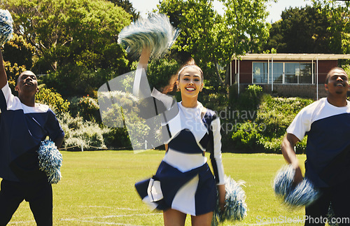 Image of Cheerleader, team and people dancing on sports field at university, uniform and props with performance. Woman, men and diversity with teamwork or training, collaboration and gymnastics with fitness