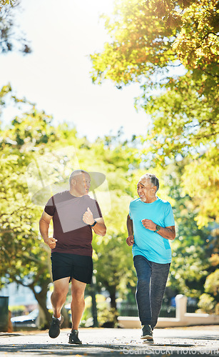 Image of Senior, men and running for exercise in road of city for wellness, fitness or workout outdoor with smile. Elderly, people and training together in nature or park for health, adventure and happiness