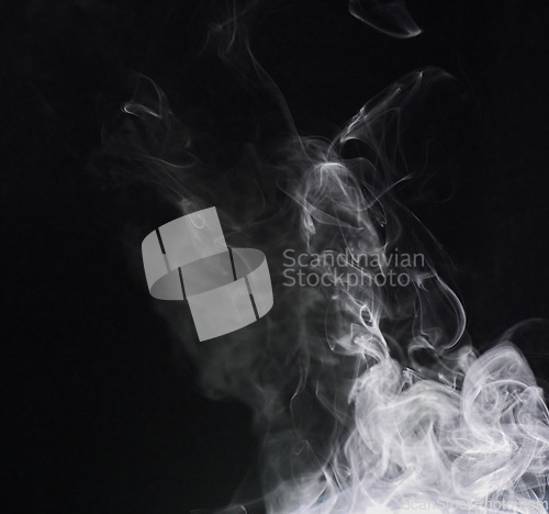 Image of Smoke, fog or gas in a studio with dark background by mockup space for magic effect with abstract. Incense, steam or vapor mist moving in air for cloud smog pattern by black backdrop with mock up.