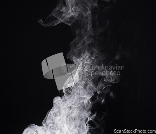 Image of Smoke, mist or gas in a studio with dark background by mockup space for magic effect with abstract. Incense, steam or vapor fog moving in air for cloud smog pattern by black backdrop with mock up.