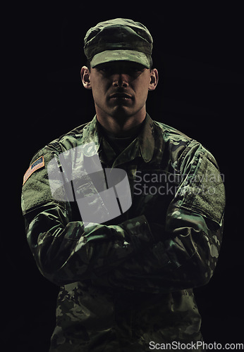 Image of Soldier, man with arms crossed and army warrior in war, conflict and battle with uniform on black background. Hero, military and camouflage with security, protection and mission for fight in studio