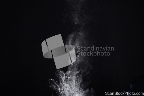 Image of Smoke, vapor or gas in a studio with dark background by mockup space for magic effect with abstract. Incense, steam or fog mist moving in air for cloud smog pattern by black backdrop with mock up.