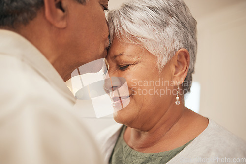 Image of Kiss, smile and senior couple in home with love, support and commitment to marriage in retirement. Embrace, face of happy man and old woman in apartment together with care, trust and romantic loyalty