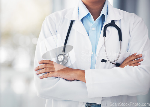 Image of Person, hands and professional doctor with arms crossed or stethoscope for cardiology or healthcare at hospital. Closeup of confident medical nurse or surgeon expert for health advice or emergency