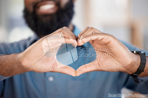 Image of Man, hands and heart with gesture in closeup, alone and blurred background. African, person or model with love, hope or support for community in solidarity with human rights, social justice or change