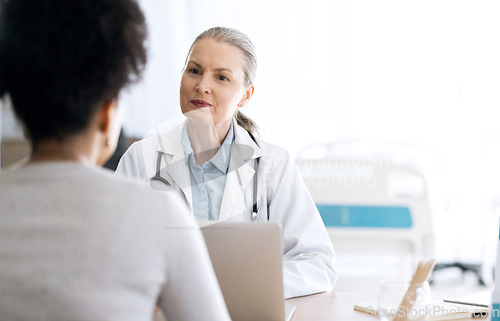 Image of Woman doctor, medical consultation and computer at hospital with patient discussion and surgery info. Wellness advice, technology and mature professional with healthcare, consulting and talking