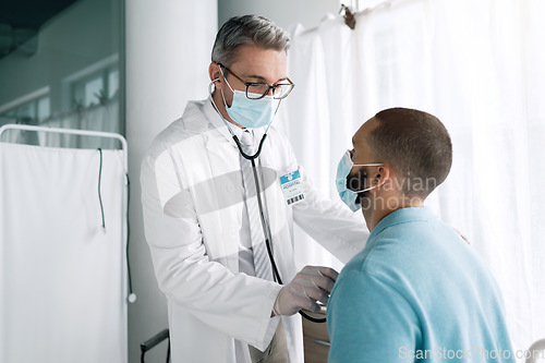 Image of Doctor, stethoscope and patient in face mask for cardiology exam, healthcare service and virus check in hospital. Medical professional listening to man heart, breathing or support in clinic for covid