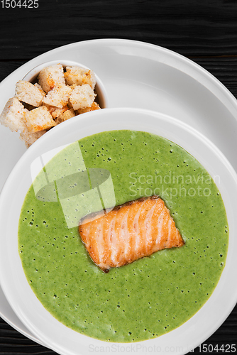 Image of Delicious green spinach cream-soup with salmon