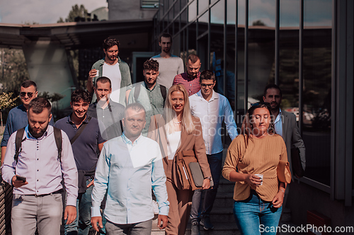 Image of A diverse group of businessmen and colleagues walking together by their workplace, showcasing collaboration and teamwork in the company.