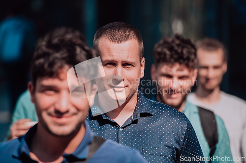 Image of A diverse group of businessmen and colleagues walking together by their workplace, showcasing collaboration and teamwork in the company.