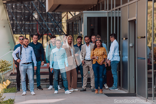 Image of A diverse group of businessmen and colleagues walking together by their workplace, showcasing collaboration and teamwork in the company.