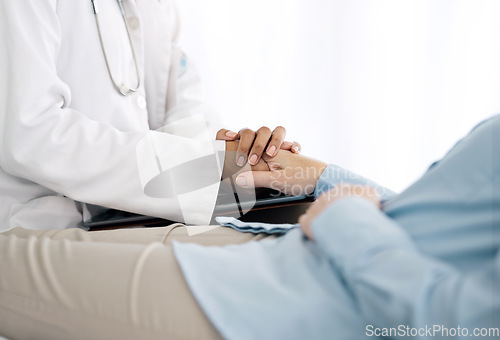 Image of Healthcare, holding hands and doctor with patient for care, comfort and empathy for diagnosis news. Hospital consulting, clinic and health worker with person for support, wellness and medical results