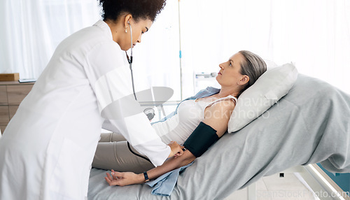 Image of Patient consultation, women and nurse hypertension test for hospital exam, client wellness or surgeon nursing service. Anatomy check, medical help or doctor monitor blood pressure, pulse or diabetes