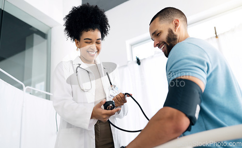 Image of Happy doctor, patient and blood pressure for appointment, checkup or visit at hospital. Medical woman, surgeon or nurse helping man, customer or client for monitoring heart rate at healthcare clinic