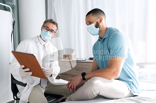 Image of Doctor, patient and tablet with face mask in healthcare consultation for charts, test results or online advice. Medical professional and man on digital tech for hospital or clinic support with virus