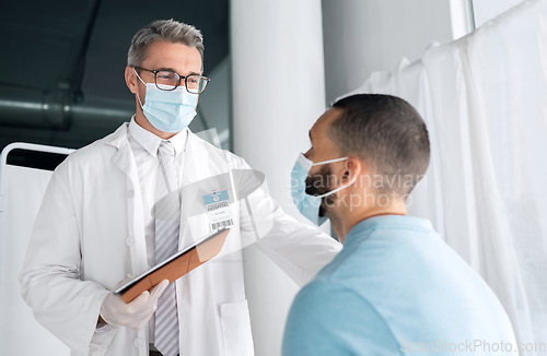 Image of Hospital men, clipboard and doctor consulting on medical results, assessment or wellness health report, support or help. Consultation exam, services and clinic expert, surgeon or nurse feedback notes