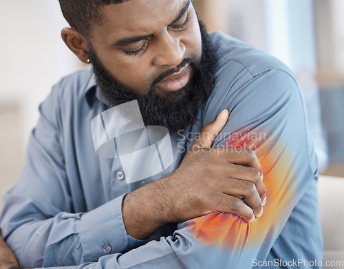 Image of Black man, arm pain and remote work with injury, muscle problem and red inflammation at home. African male person, freelancer shoulder and joint damage with heart attack warning and stress in house
