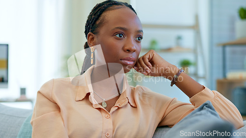 Image of Thinking, worry and black woman on couch with a problem, crisis and ideas of stress in a home living room. Fear, house and person scared and anxious about a mistake, fail or unhappy on a sofa