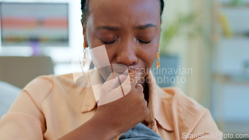 Image of Crying, sad and black woman on couch with a problem, crisis and frustrated by stress in a home living room. Fear, house and person scared and anxious about a mistake, fail or unhappy on a sofa