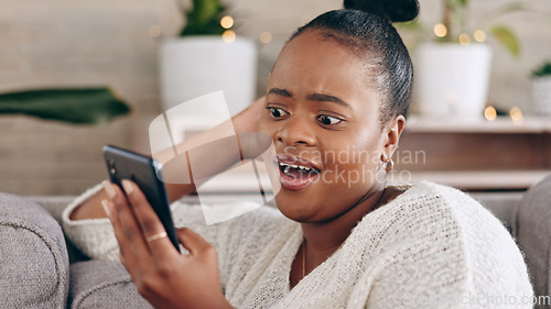 Image of Phone, video call and black woman on a sofa happy, smile and relax in her home. Internet, conversation and female chilling in a living room while reading, browsing and enjoy streaming subscription