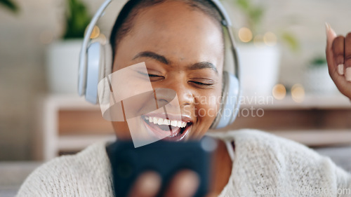 Image of Black woman, headphones and music with smartphone and happiness, audio streaming and fun while at home. Listening to radio, sound and smile for playlist with energy, dancing and mobile app in lounge