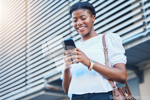 Image of Cellphone, walking and young woman in the city networking on social media, mobile app or the internet. Happy, technology and African female person scroll on a phone and commuting in urban town street