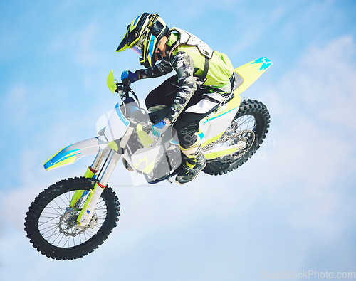 Image of Motorbike, jump and man in the air with blue sky, mock up and stunt in sports with fearless person in danger with freedom. Motorcycle, jumping and athlete training for challenge or competition