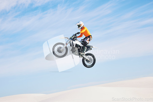 Image of Motorcycle, jump and man in the air with blue sky, mock up and stunt in sports with fearless person in danger with freedom. Motorbike, jumping and athlete training for challenge or competition