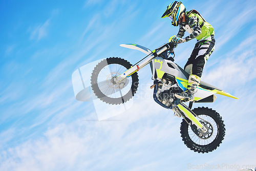 Image of Training, person and motorbike with sky background, fitness and exercise with competition. Biker, practice and athlete with a bike, sports and health with cycling, travel and freedom with energy