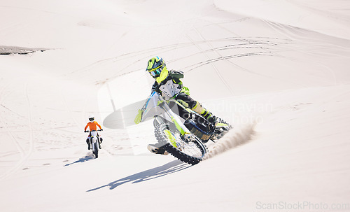 Image of Motorcycle, desert sand and moto sport with people outdoor on hill with race, journey and adventure. Extreme, workout and motorbike challenge of biker with driving exercise and training in Dubai
