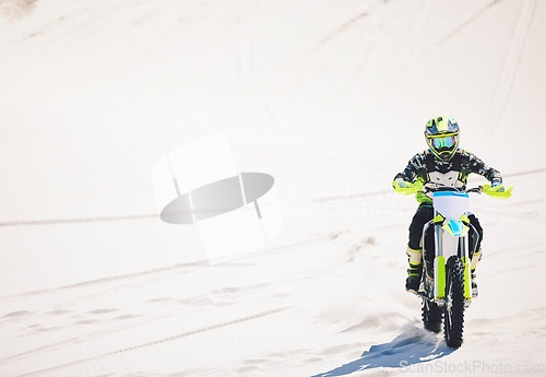 Image of Man, driving and motorbike on sand for sport, adventure or competition outdoor in summer or mockup space. Motorcycle, ride and athlete on dirt, dune or desert for race, danger and fearless challenge