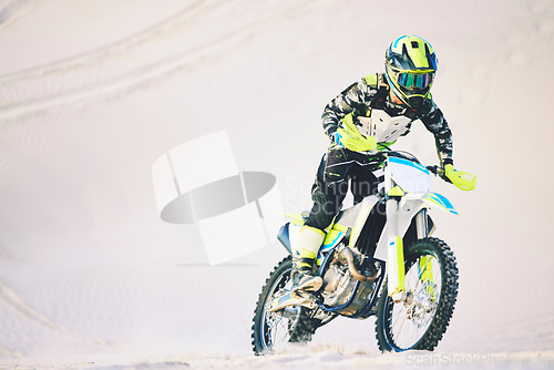 Image of Driving, motorbike and man on sand for sport, adventure or competition outdoor in summer or mockup space. Motorcycle, ride and athlete on dirt, dune or desert for race, danger and fearless challenge