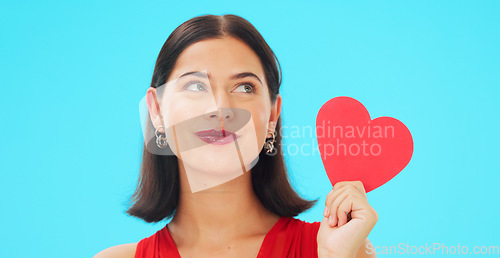 Image of Thinking, happy and woman with paper heart in studio isolated on a blue background mockup. Idea, romance and model with love sign for anniversary, emoji and smile for valentines day gift or present