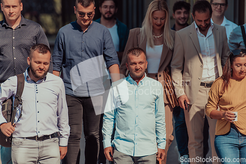 Image of A diverse group of businessmen and colleagues walking together by their workplace, showcasing collaboration and teamwork in the company.