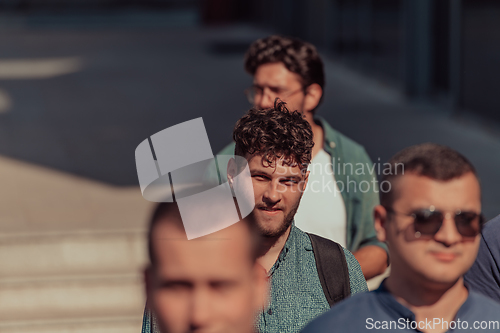 Image of A diverse group of businessmen and colleagues walking together by their workplace, showcasing collaboration and teamwork in the company.