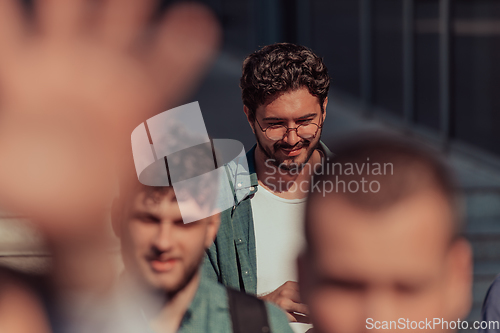 Image of A diverse group of businessmen and colleagues walking together by their workplace, showcasing collaboration and teamwork in the company.