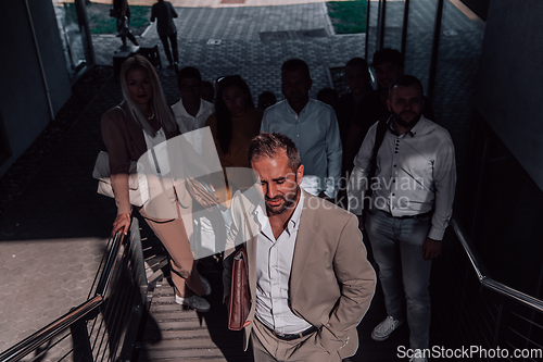 Image of A diverse group of businessmen and colleagues walking together by their workplace, showcasing collaboration and teamwork in the company.