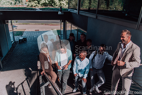 Image of A diverse group of businessmen and colleagues walking together by their workplace, showcasing collaboration and teamwork in the company.