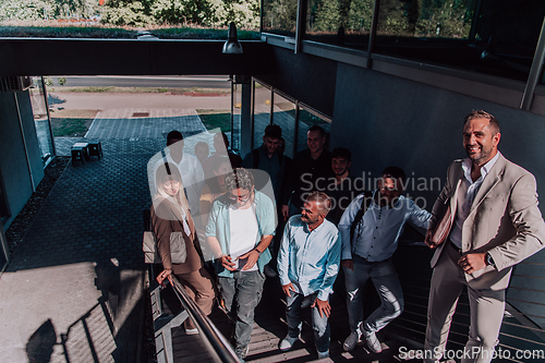 Image of A diverse group of businessmen and colleagues walking together by their workplace, showcasing collaboration and teamwork in the company.