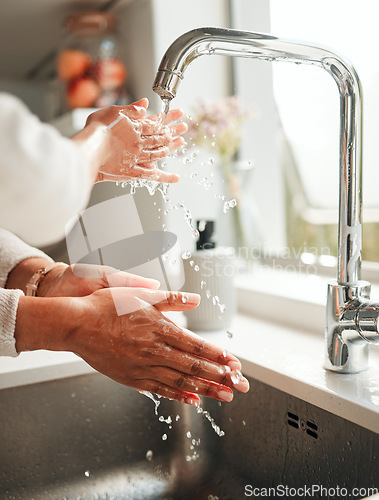 Image of Hygiene, water and washing hands in a kitchen basin for health, cleaning and fresh before cooking. Morning, sustainability and a person with liquid for home sanitation, purity and routine in a sink