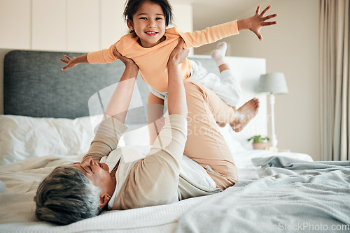 Image of Woman, girl child and bed for airplane game, portrait and smile with lift, flying and bonding in family home. Senior lady, kid and plane with flight, love and care with freedom, balance and fantasy