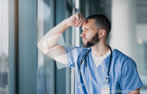 Image of Window, doctor and man with stress, thinking and mental health with burnout, overworked and depression. Person, employee and medical professional with thoughts, healthcare and anxiety with doubt