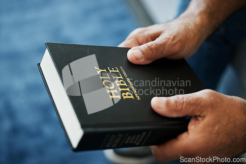 Image of Bible, book and hands of man in home with study of Christian faith, religion or spirituality knowledge. Holy, worship and person with gospel, scripture or learning about God or story of Jesus Christ