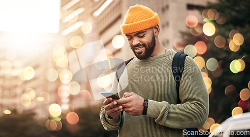 Image of Phone, man and outdoor chat, network and social media for startup business or freelance marketing in city bokeh. African person typing on mobile for information, contact or travel FAQ in urban street