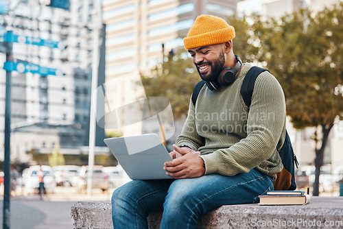 Image of Student, man and laptop in city for college application, university research or scholarship website information. Happy african person on computer, typing and studying philosophy or language on campus